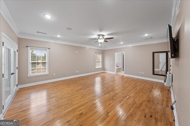 unfurnished living room with ceiling fan, light hardwood / wood-style flooring, and crown molding