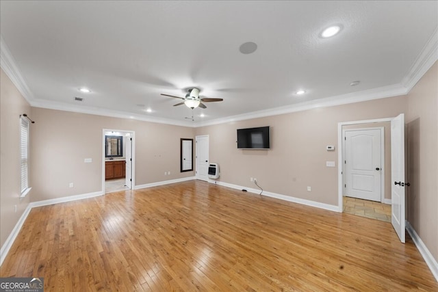 unfurnished living room featuring heating unit, ceiling fan, ornamental molding, and light hardwood / wood-style floors