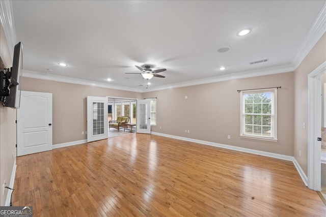 unfurnished living room featuring light hardwood / wood-style floors, ceiling fan, crown molding, and french doors