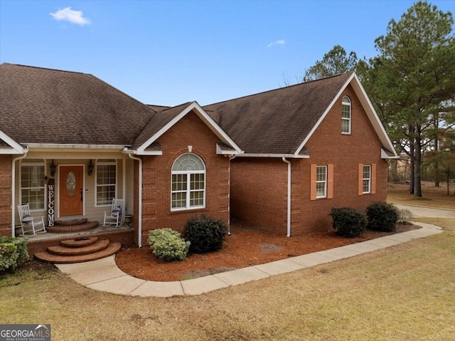 view of front of house featuring a front yard and a porch