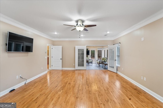 interior space with french doors, ornamental molding, and light hardwood / wood-style floors