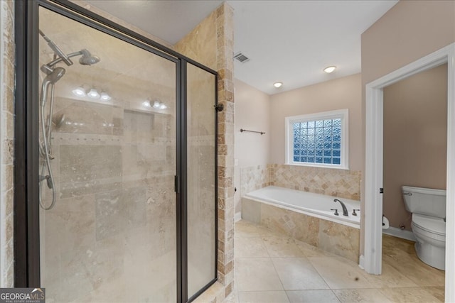 bathroom with tile patterned floors, toilet, and plus walk in shower