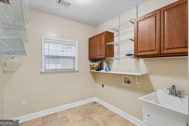 laundry room with cabinets, sink, hookup for a washing machine, and hookup for an electric dryer