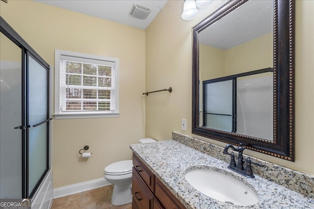 full bathroom with bath / shower combo with glass door, toilet, and vanity