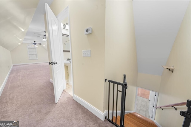 interior space featuring light carpet and lofted ceiling