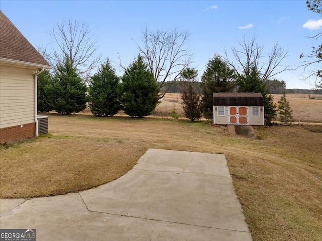 view of yard with a patio and a storage shed