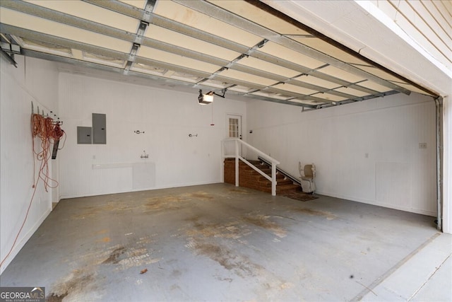 garage with electric panel and a garage door opener