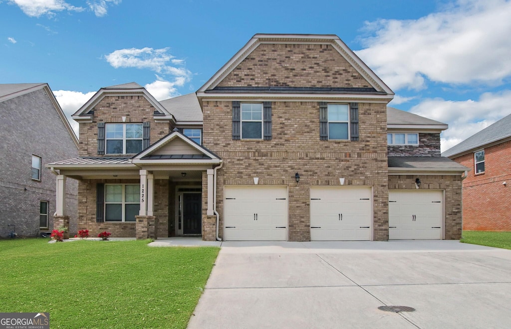 craftsman inspired home featuring a garage and a front lawn