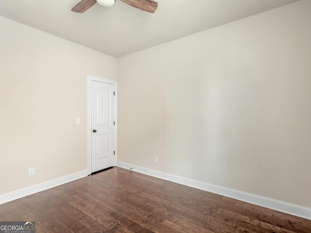 unfurnished room with dark wood-style floors, baseboards, and a ceiling fan