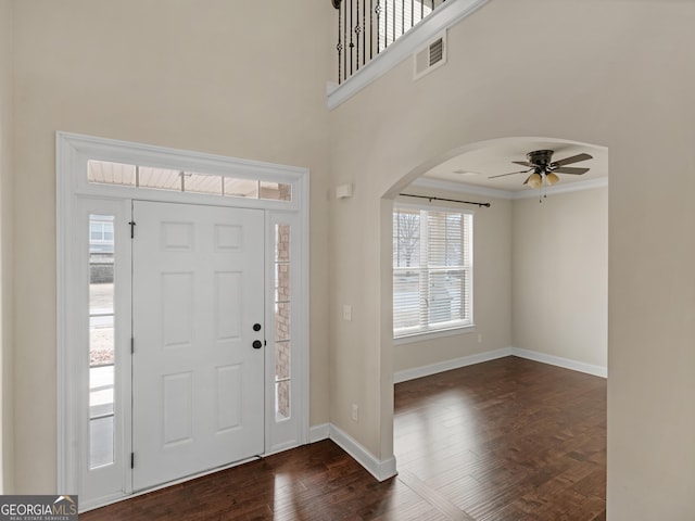 entryway featuring crown molding, dark hardwood / wood-style floors, and ceiling fan