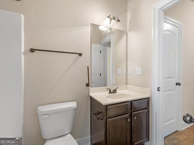 bathroom featuring vanity and toilet