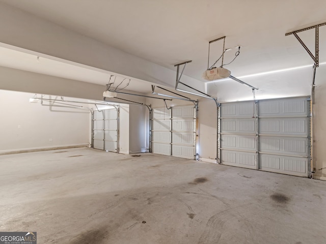 garage featuring baseboards and a garage door opener