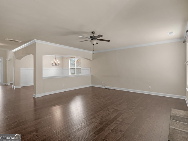 unfurnished living room with arched walkways, dark wood-style flooring, visible vents, ornamental molding, and ceiling fan with notable chandelier