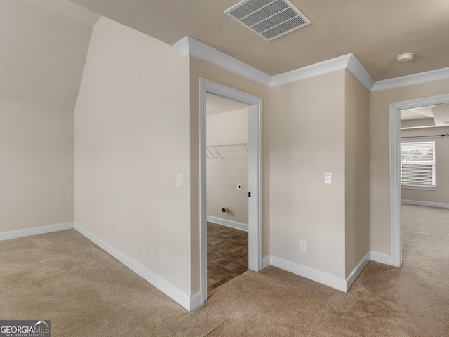 interior space featuring light carpet, baseboards, visible vents, and ornamental molding