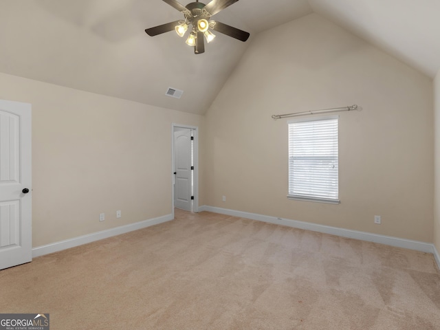 interior space with baseboards, high vaulted ceiling, visible vents, and light colored carpet