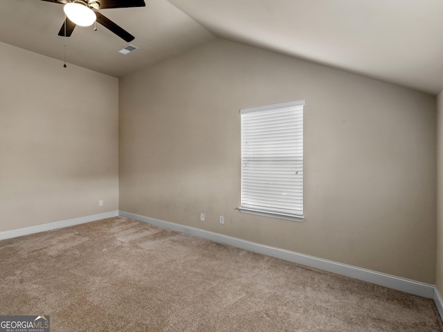 interior space with lofted ceiling, light carpet, visible vents, and baseboards