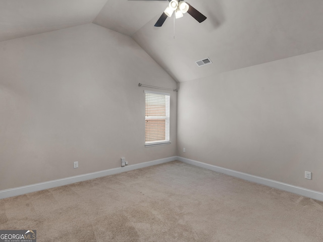 interior space with lofted ceiling, visible vents, and light colored carpet