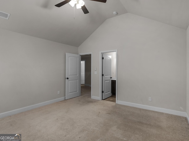 unfurnished bedroom with light carpet, lofted ceiling, visible vents, and baseboards