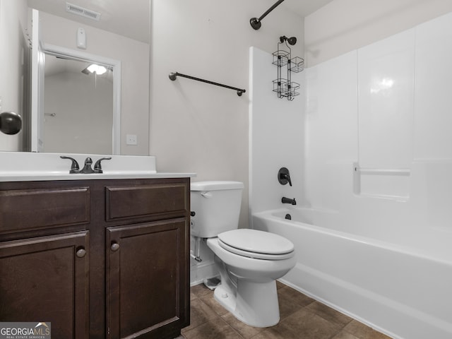 full bathroom featuring visible vents, toilet, washtub / shower combination, vanity, and tile patterned floors