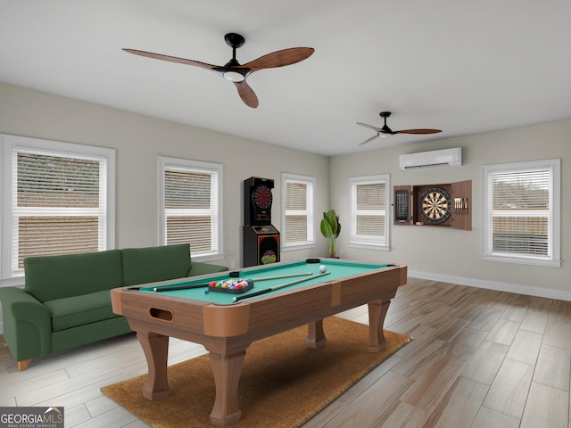 recreation room featuring baseboards, pool table, light wood finished floors, and a wall mounted AC