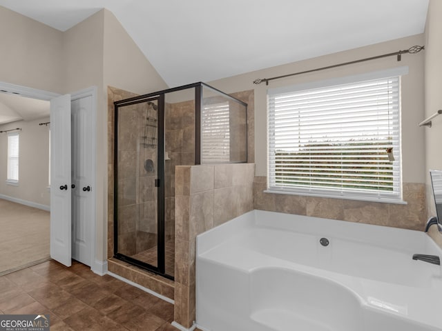 full bath featuring vaulted ceiling, a stall shower, and a garden tub