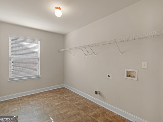 clothes washing area featuring laundry area, hookup for a washing machine, electric dryer hookup, and baseboards