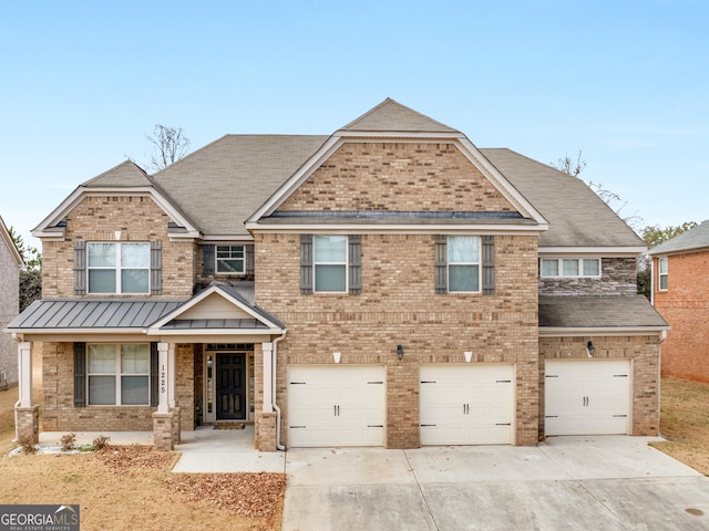 craftsman house featuring metal roof, an attached garage, brick siding, driveway, and a standing seam roof