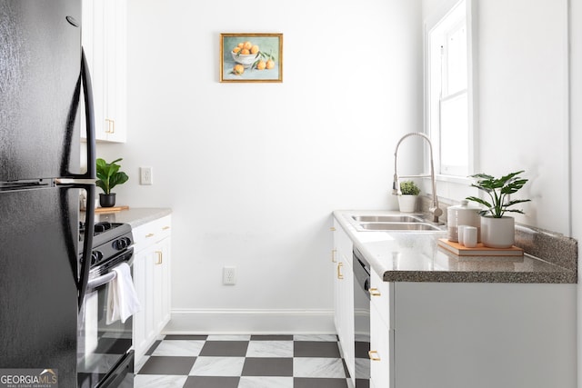 kitchen with sink, black appliances, and white cabinets