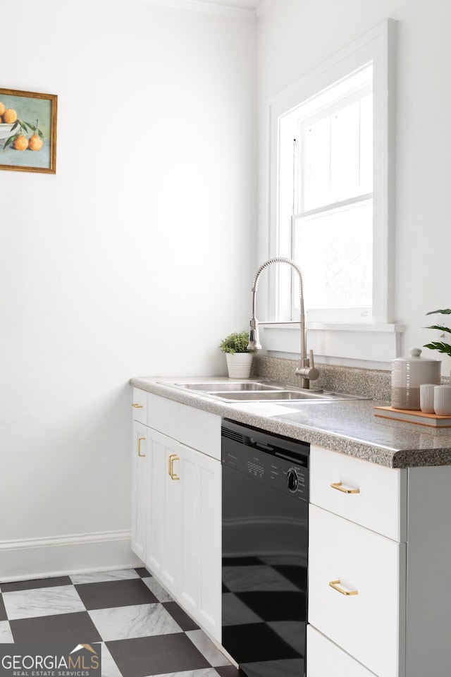 kitchen featuring black dishwasher, sink, and white cabinets