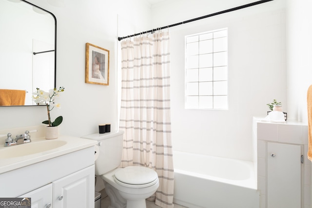 full bathroom with vanity, shower / tub combo, and toilet