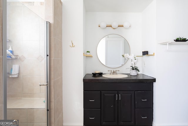 bathroom featuring vanity and a shower with shower door