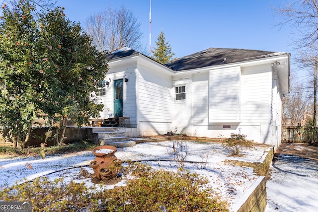 view of snow covered rear of property