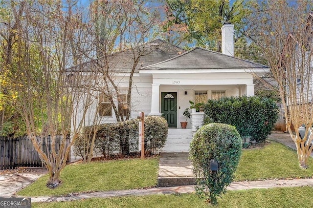 view of front facade with a porch and a front lawn