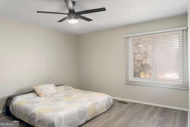 bedroom featuring ceiling fan and light hardwood / wood-style floors