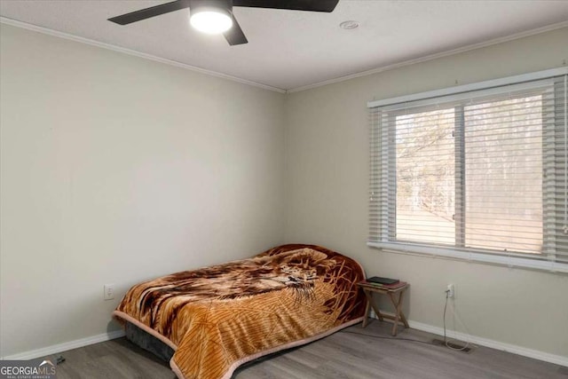 bedroom with wood-type flooring, ceiling fan, and ornamental molding