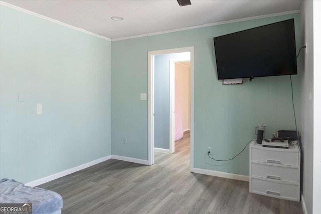 interior space featuring crown molding and hardwood / wood-style floors