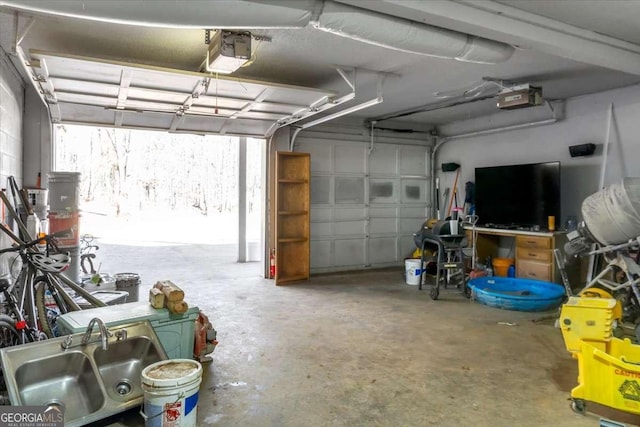 garage featuring sink and a garage door opener