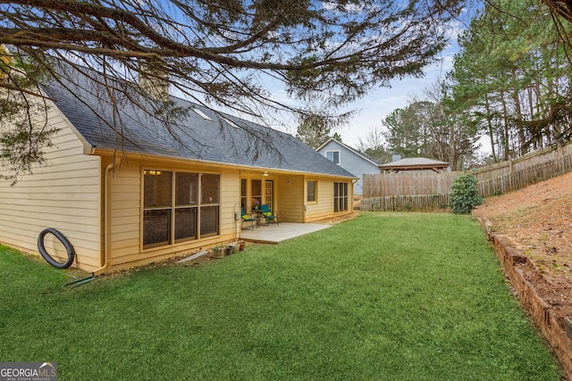 rear view of property featuring a gazebo, a lawn, and a patio