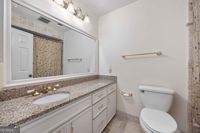 bathroom featuring vanity, a shower with shower curtain, and toilet