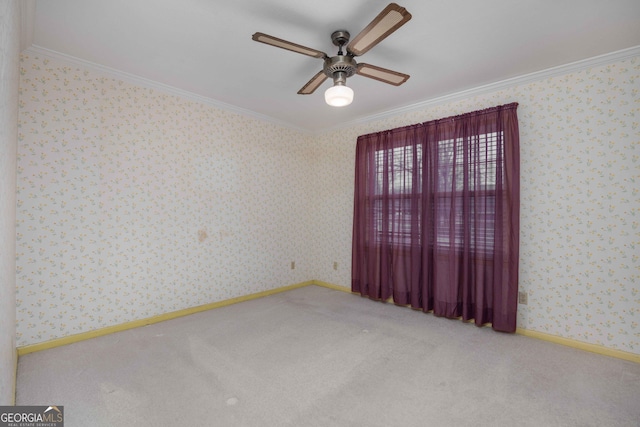 carpeted spare room featuring ornamental molding and ceiling fan