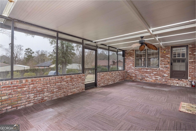 unfurnished sunroom featuring plenty of natural light and ceiling fan