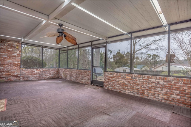 unfurnished sunroom with ceiling fan