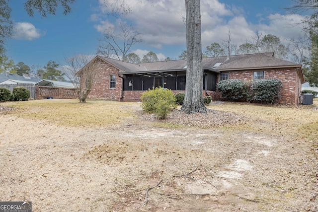 exterior space with central AC unit, a sunroom, and a carport