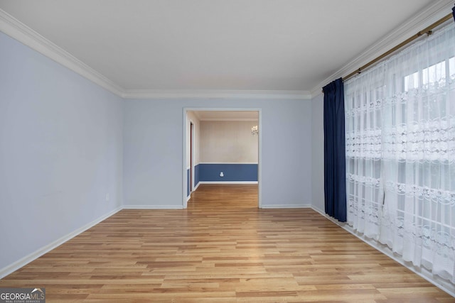 unfurnished room with ornamental molding and light wood-type flooring