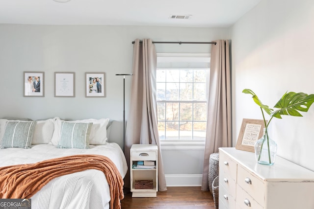 bedroom with dark hardwood / wood-style floors