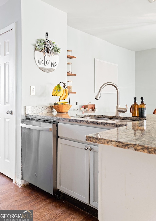 kitchen with sink, gray cabinets, stone counters, dark hardwood / wood-style floors, and stainless steel dishwasher