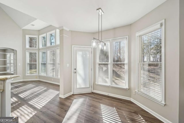 unfurnished dining area with dark hardwood / wood-style flooring