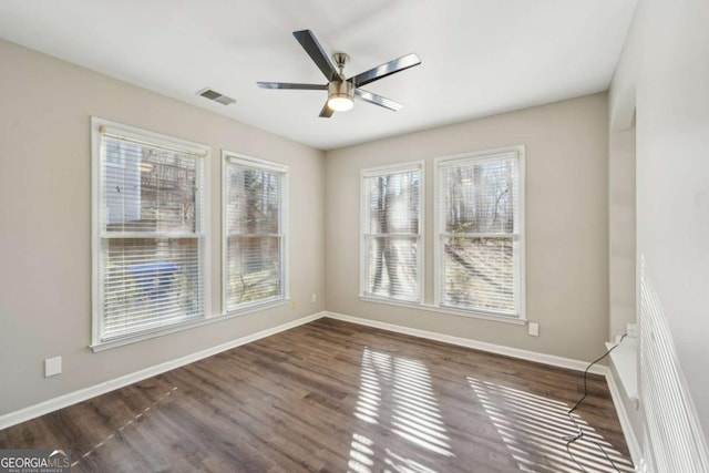 empty room featuring ceiling fan and dark hardwood / wood-style floors