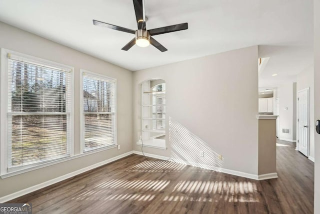 spare room featuring ceiling fan and dark hardwood / wood-style floors