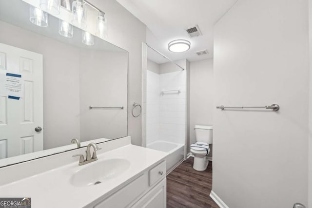 full bathroom featuring shower / tub combination, toilet, vanity, and hardwood / wood-style floors